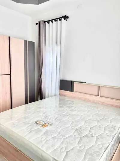 Spacious bedroom with modern wardrobe and natural light
