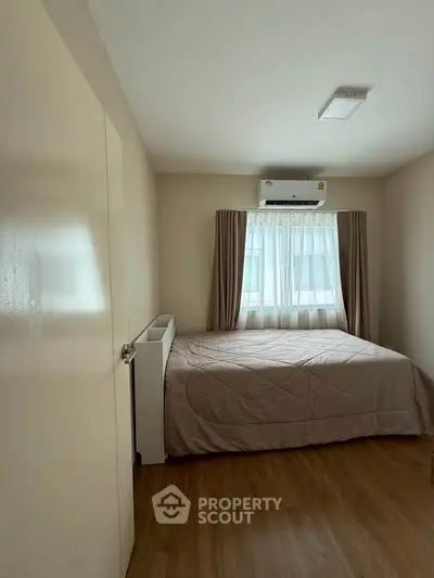 Cozy bedroom with natural light and modern air conditioning unit