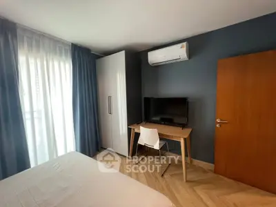 Modern bedroom with air conditioning, wardrobe, and desk setup.