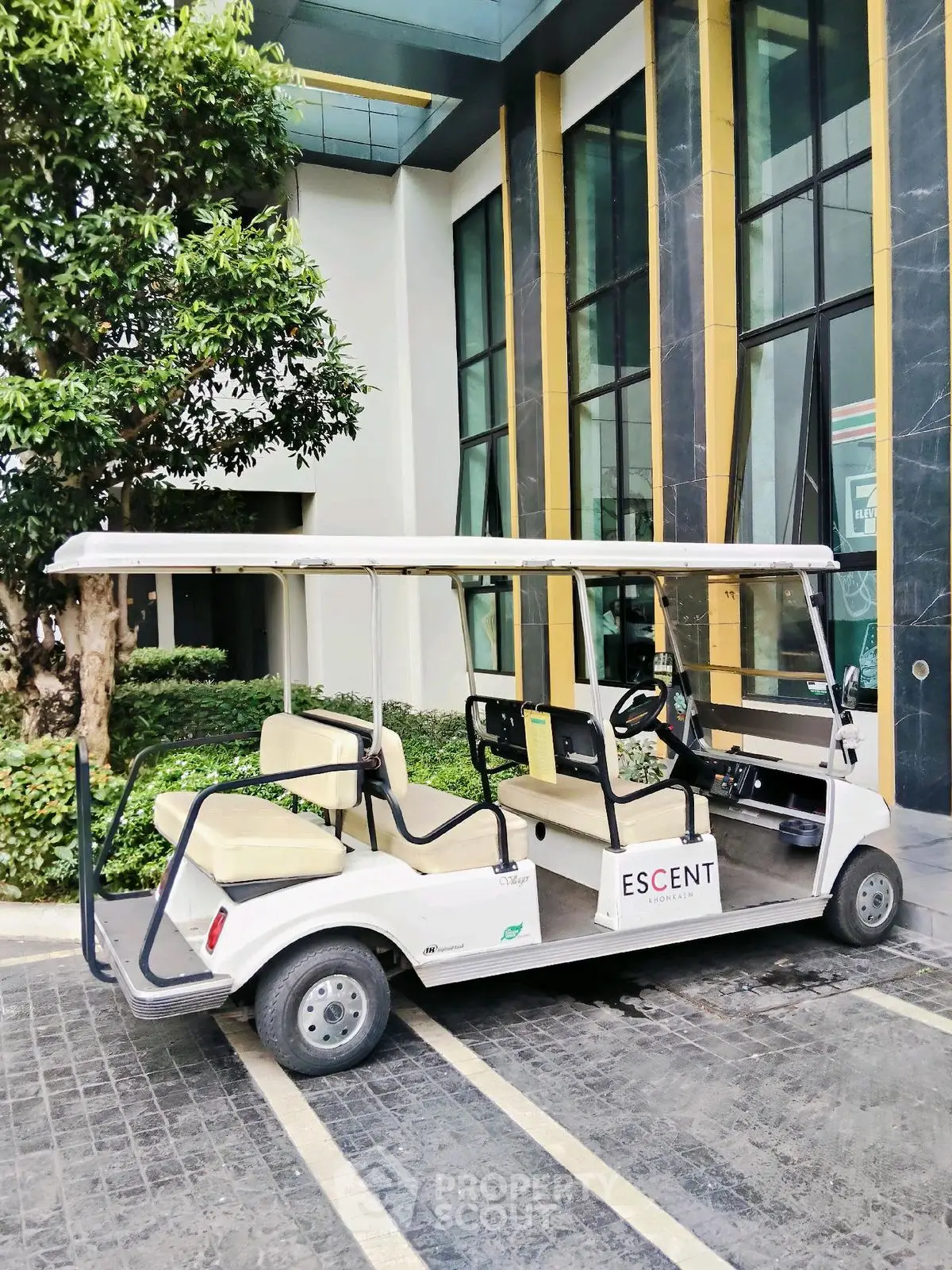 Luxurious modern building entrance with golf cart for convenient transportation.