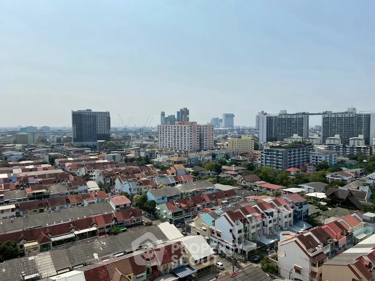 Panoramic cityscape view showcasing diverse residential and commercial buildings under a clear sky.