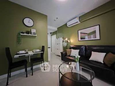 Modern living room with green accent wall and sleek black furniture