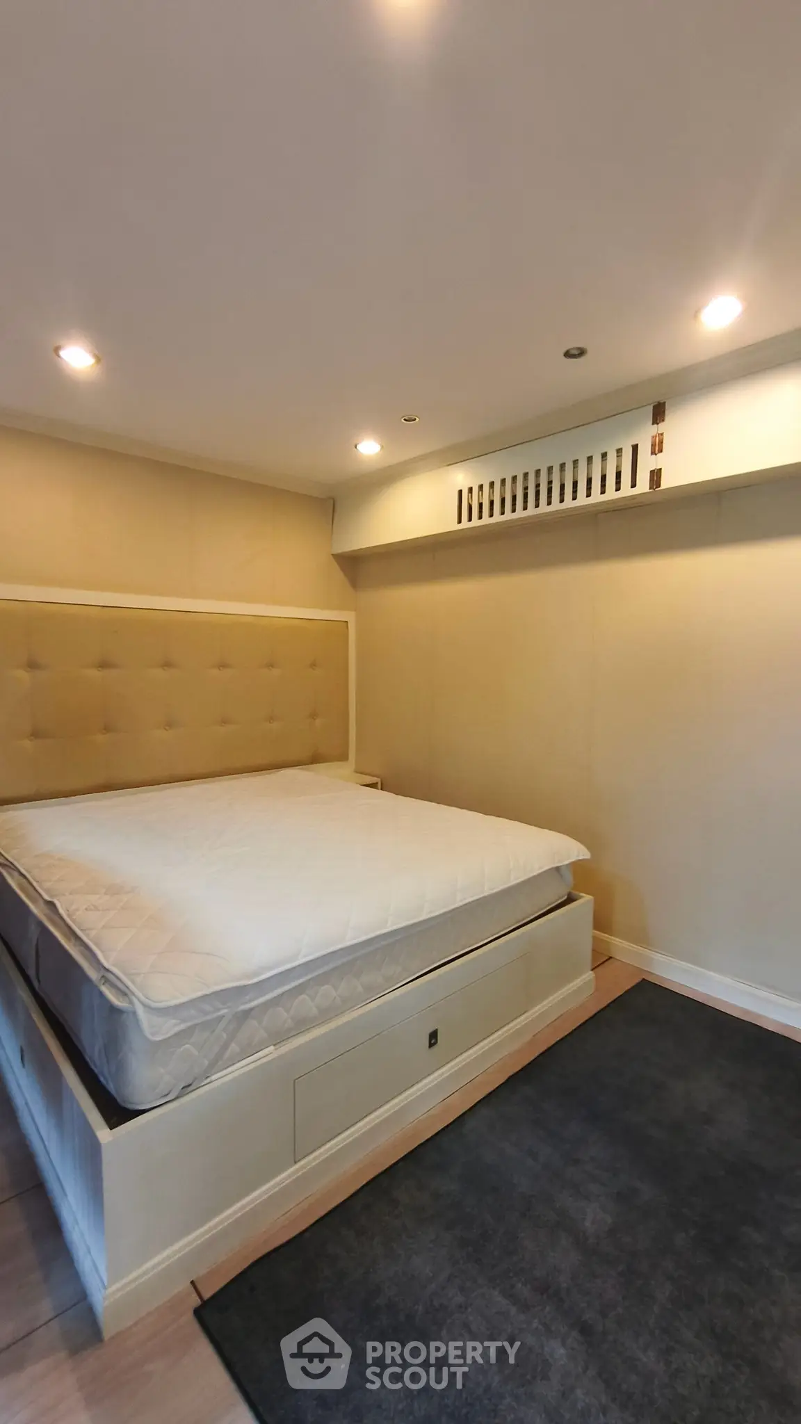 Spacious bedroom with elegant design and cozy lighting, featuring a plush bed and modern decor.