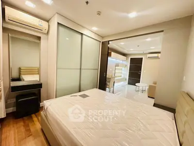 Modern bedroom with sliding closet doors and air conditioning in a stylish apartment.