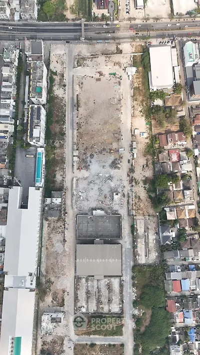 Aerial view of urban construction site with surrounding buildings and roads.