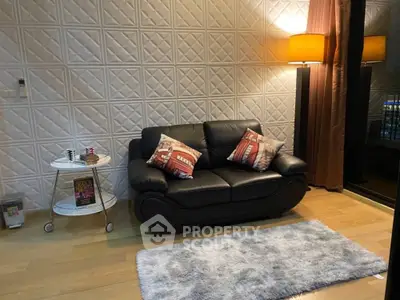 Cozy living room with stylish black leather sofa and elegant lighting