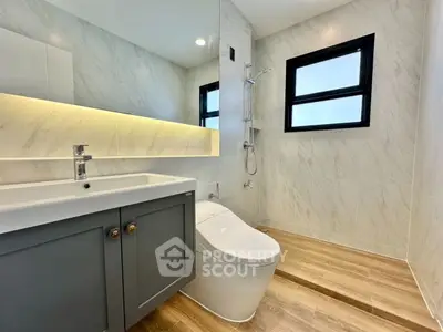 Modern bathroom with sleek design, featuring a stylish vanity and contemporary fixtures.