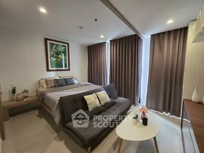 Modern bedroom with stylish decor and cozy seating area, perfect for relaxation.