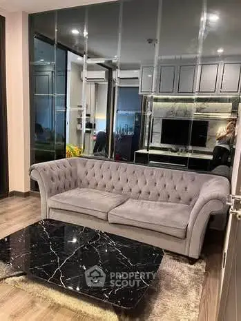 Luxurious living room with elegant gray sofa and sleek black marble coffee table.