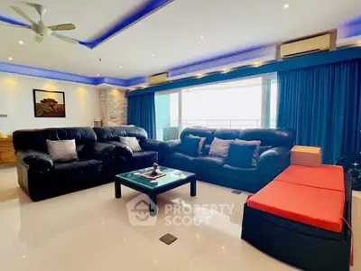 Spacious living room with modern decor and large windows for natural light.