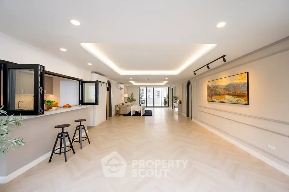 Spacious open-plan living area with modern kitchen and elegant decor