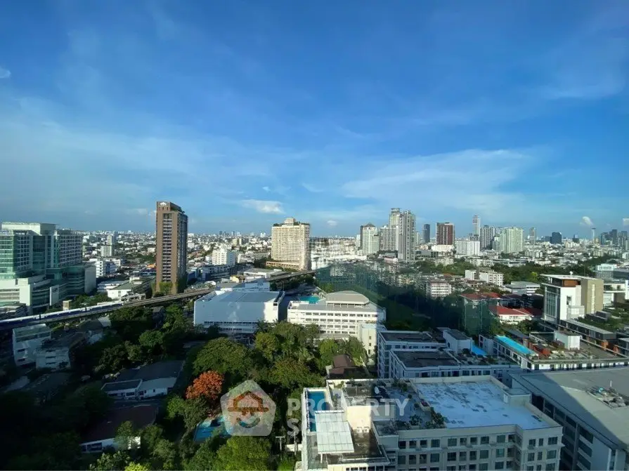 Stunning cityscape view from high-rise building showcasing urban skyline and lush greenery.