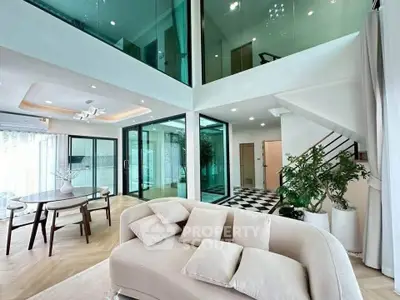 Luxurious modern living room with high ceilings and elegant decor