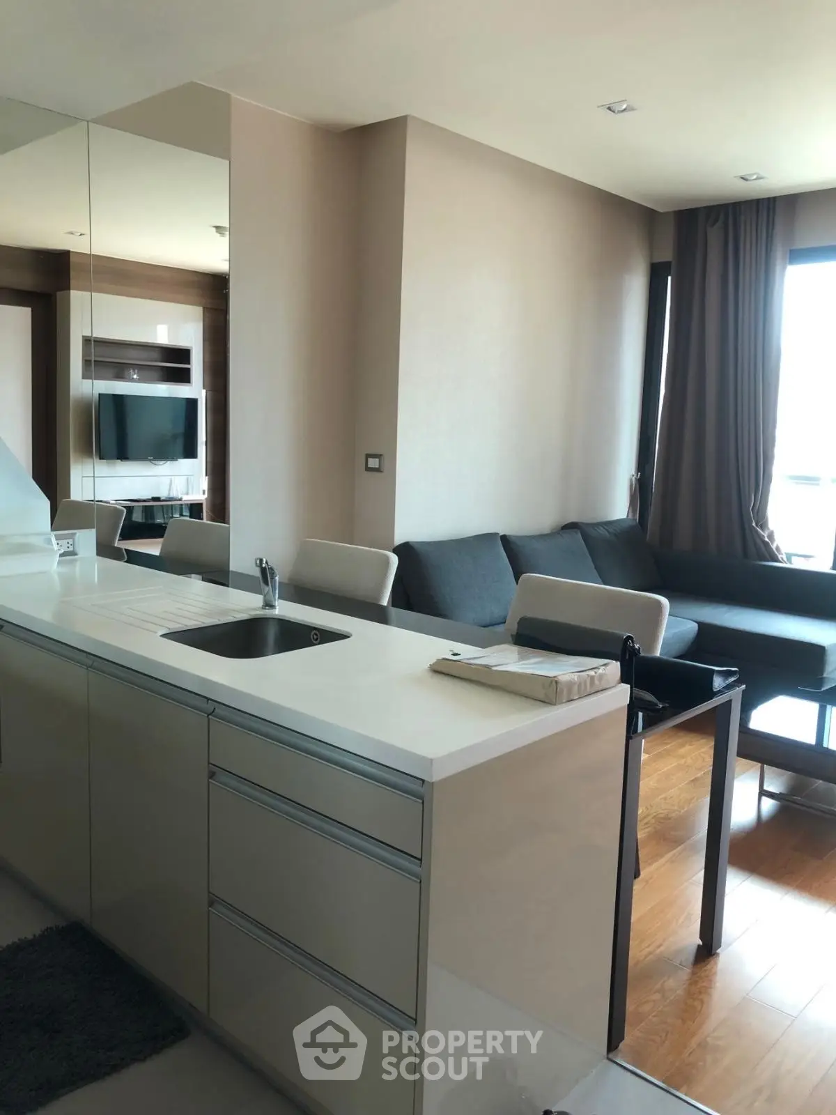 Modern open-layout living room with sleek kitchen and stylish furniture