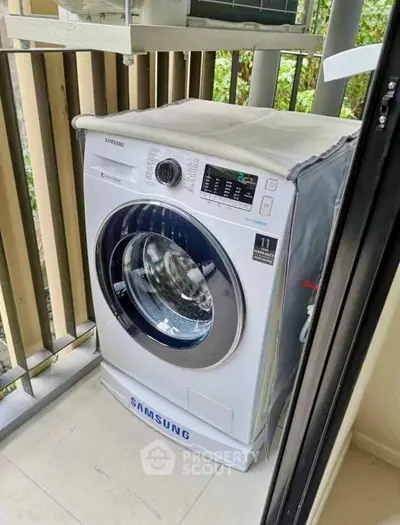 Modern Samsung washing machine on a balcony with sleek design and advanced features.