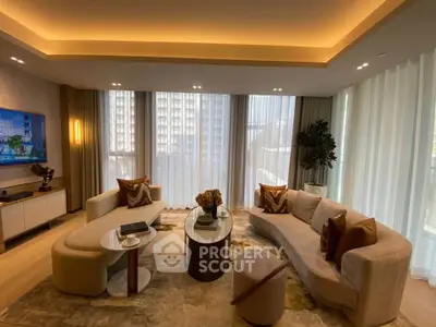 Luxurious living room with modern furniture and large windows offering city views.
