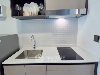 Modern kitchen with sleek induction cooktop and stylish backsplash