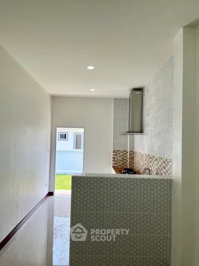Modern kitchen with sleek design and gas stove in a bright, open space.