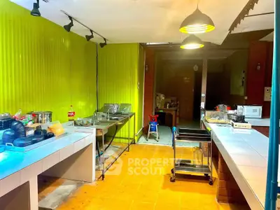 Spacious kitchen with vibrant yellow walls and modern lighting