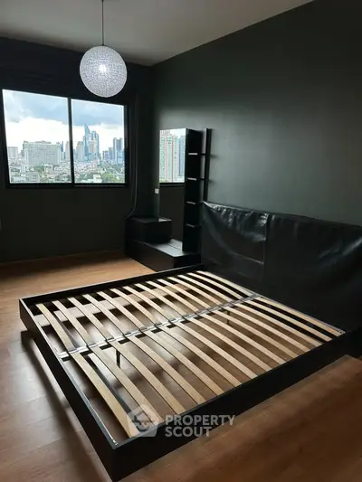 Spacious bedroom with city view and modern bed frame, ideal for urban living.