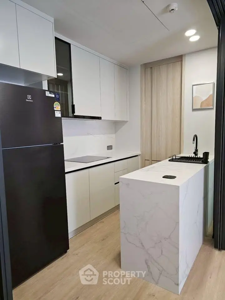 Modern kitchen with sleek white cabinets and marble island
