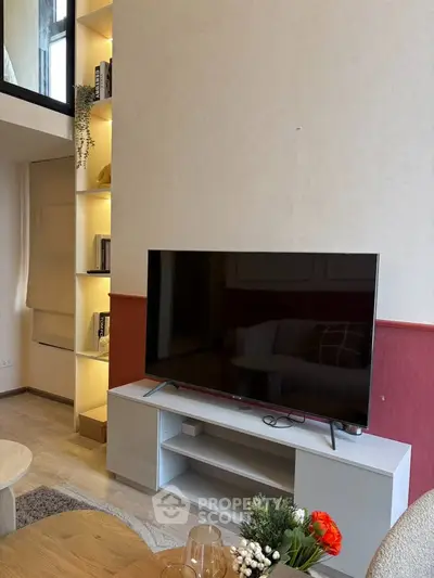 Modern living room with stylish TV setup and elegant shelving