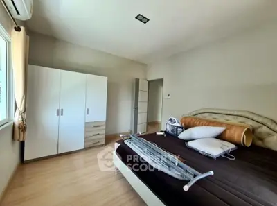 Spacious bedroom with modern furniture and natural light