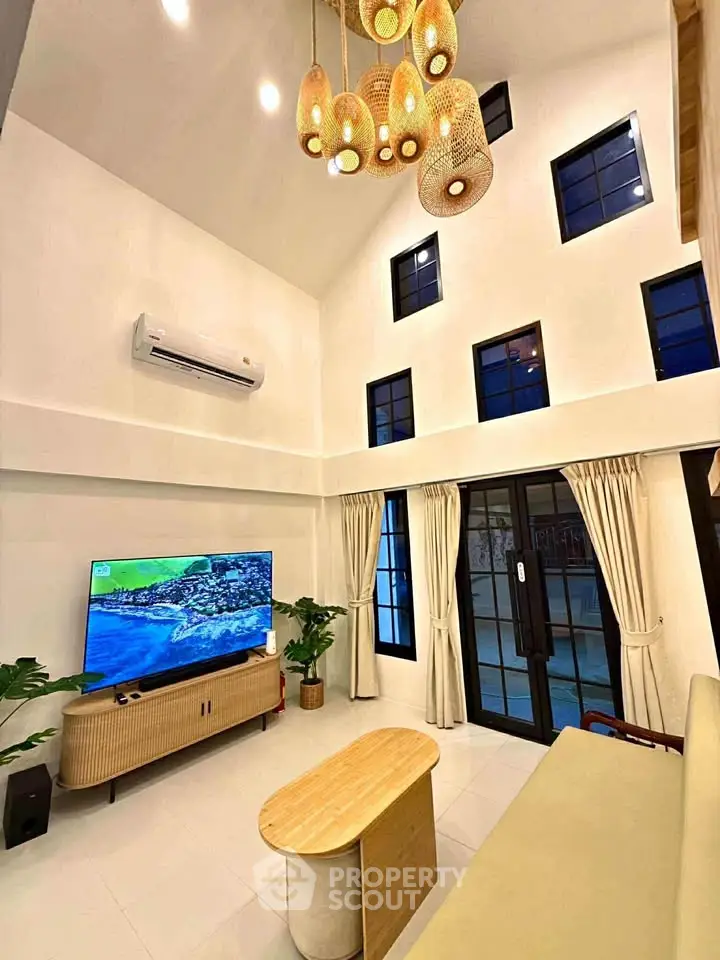 Stunning high-ceiling living room with modern decor and large windows