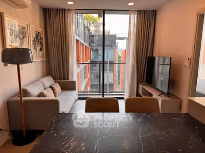 Modern living room with large window and stylish decor in urban apartment