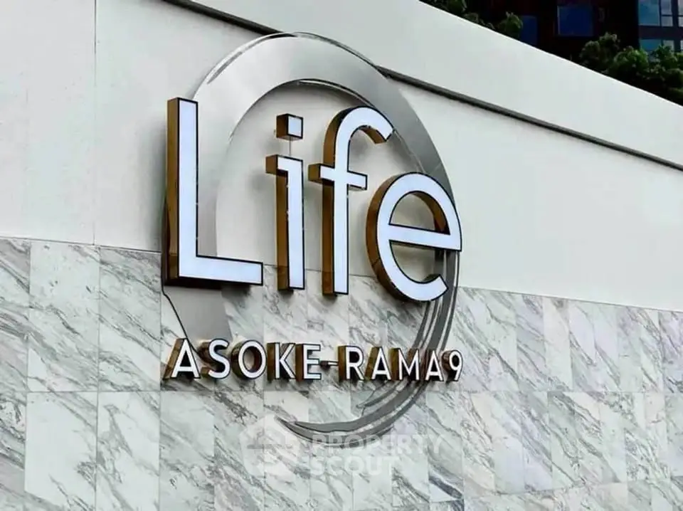 Modern building facade with Life Asoke Rama 9 signage in elegant design.