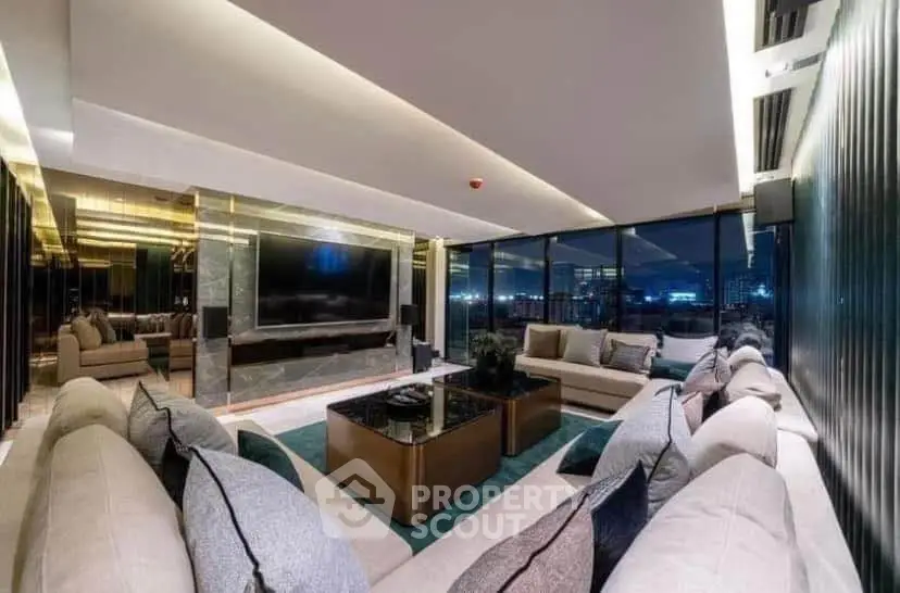 Luxurious modern living room with panoramic city views and elegant furnishings.