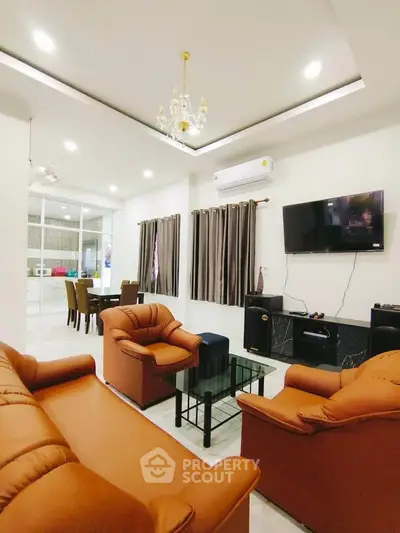 Luxurious living room with elegant chandelier and modern furnishings