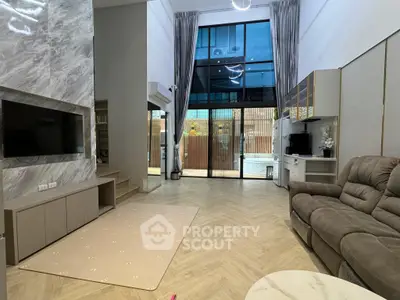 Spacious modern living room with high ceilings and large windows