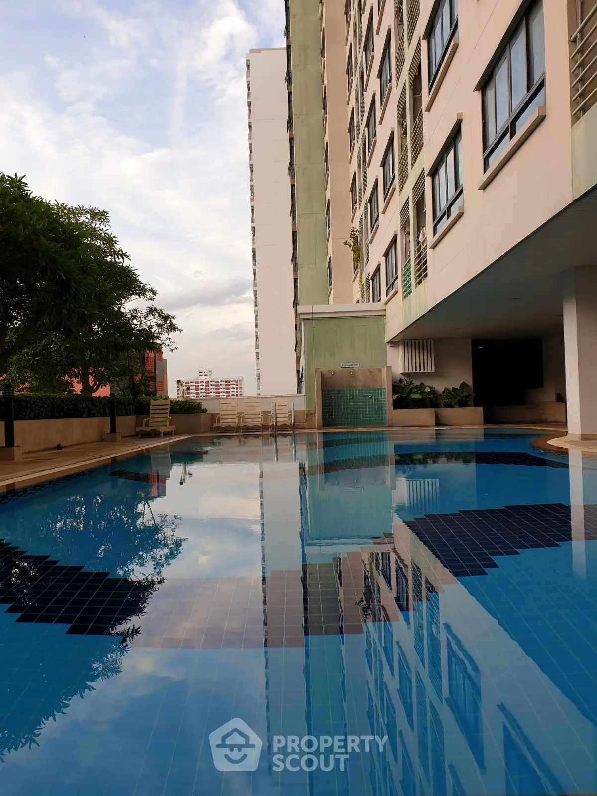 Luxurious apartment complex with a stunning swimming pool and modern architecture.