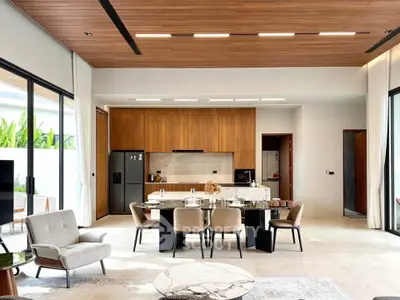 Luxurious open-plan living and dining area with modern kitchen and elegant decor