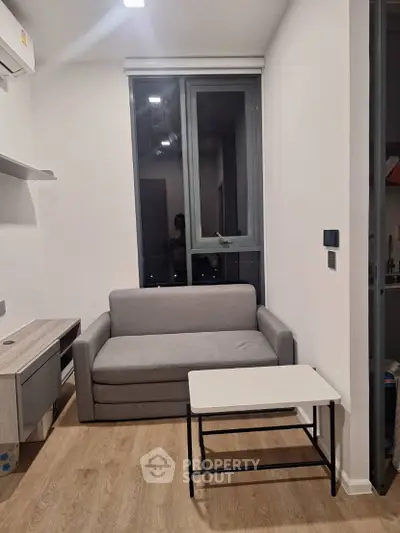 Cozy modern living room with compact sofa and sleek decor