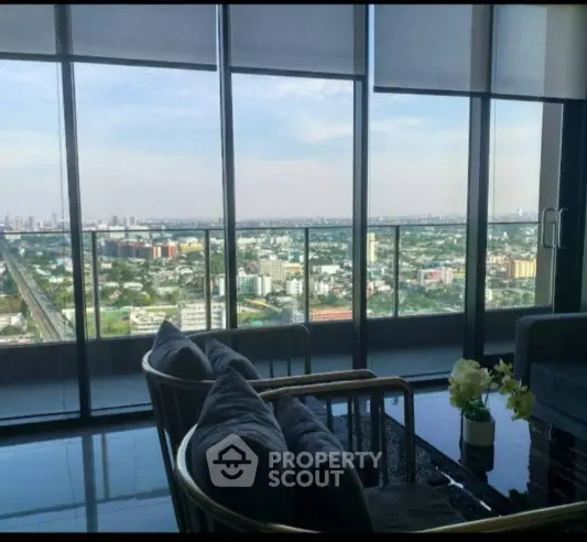 Luxurious high-rise living room with stunning city view and modern decor.