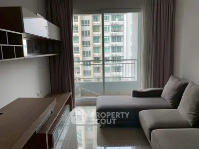 Modern living room with sleek furniture and large window offering city view