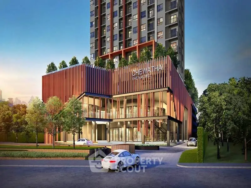 Modern high-rise building exterior with lush greenery and luxury cars, showcasing urban elegance.