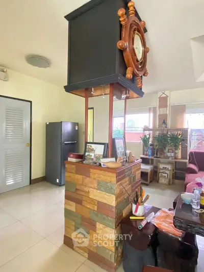 Charming living room with unique decor and natural light, featuring a cozy seating area and modern appliances.