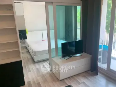 Modern studio apartment with sliding glass doors and natural light