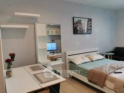 Cozy bedroom with modern decor and workspace, ideal for urban living.