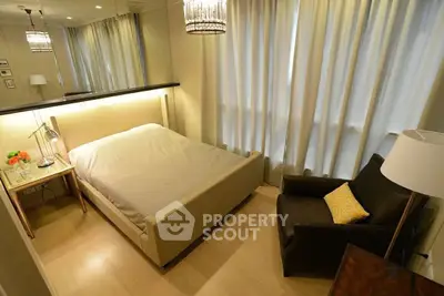 Cozy bedroom with elegant lighting and comfortable seating, perfect for relaxation.