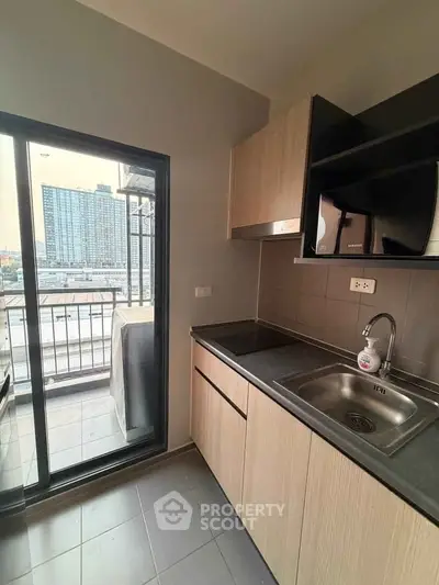 Modern kitchen with balcony view in urban apartment