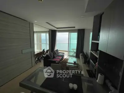 Stunning beachfront living room with panoramic ocean views and modern furnishings.