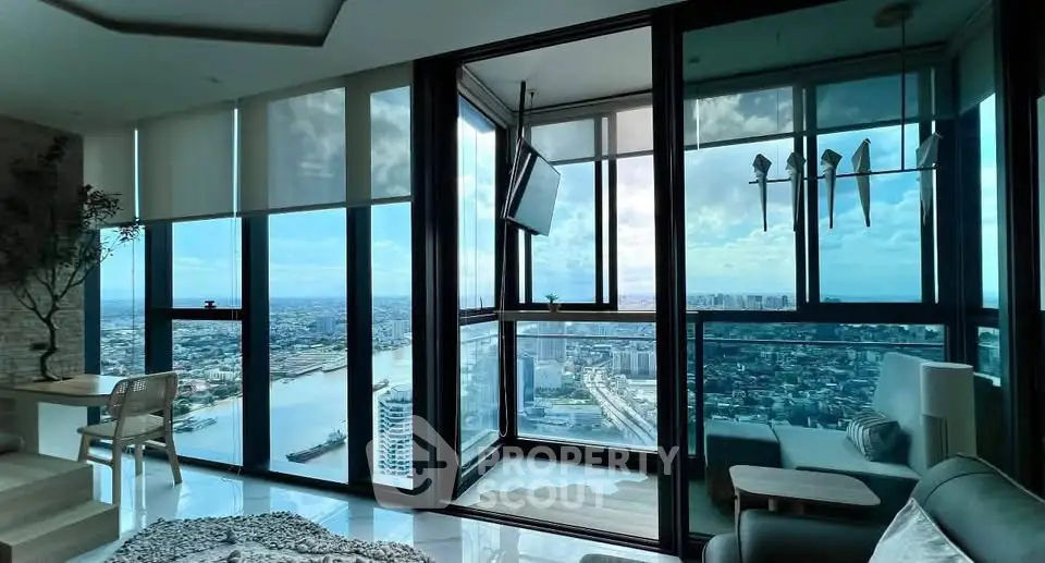Stunning high-rise apartment with panoramic city and river views, featuring floor-to-ceiling windows and modern decor.