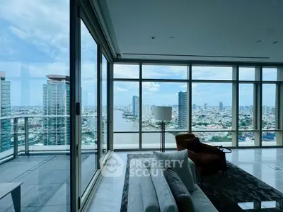 Luxurious high-rise living room with panoramic city and river views, featuring floor-to-ceiling windows and modern decor.