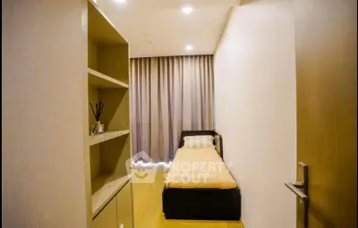 Cozy single bedroom with modern decor and ample natural light