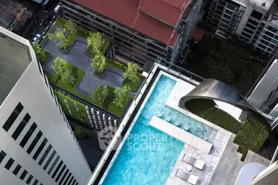 Stunning rooftop pool with cityscape view and lush greenery in modern high-rise building.
