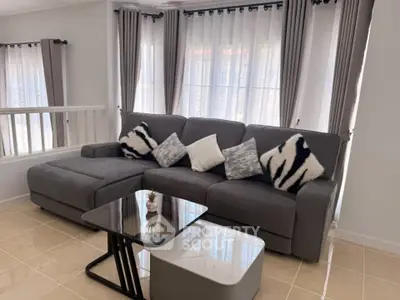 Stylish living room with modern gray sofa and chic decor in bright natural light.